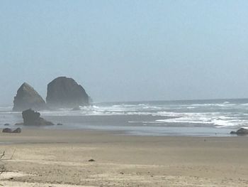 Scenic view of beach against clear sky