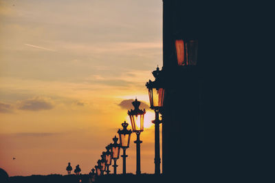 Low angle view of built structure against sky at sunset