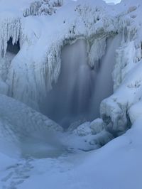 Scenic view of snow covered waterfall