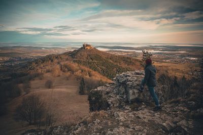 Man standing on land against sky