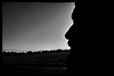 Close-up portrait of silhouette man against sky during sunset