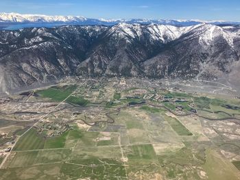 Aerial view of snowcapped mountains against sky