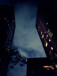 Low angle view of illuminated building against sky at night