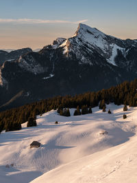 Scenic view of snow covered mountains against sky