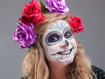 Close-up of woman with spooky face paint at home during halloween