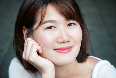 Close-up portrait of smiling young woman