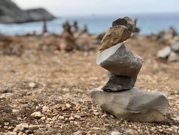 Close-up of stone stack on rock at beach