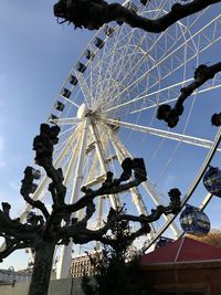 Low angle view of ferris wheel against sky