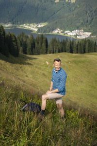 Full length of man sitting on field