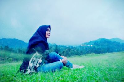 Man sitting on grassy field