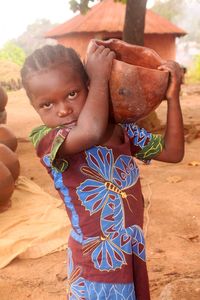 Portrait of happy girl standing on land