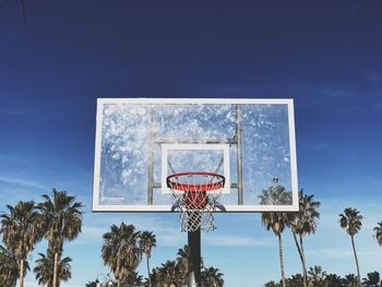 Low angle view of basketball hoop against blue sky