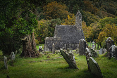 Medieval church, ancient graves, celtic crosses in glendalough cemetery, ireland