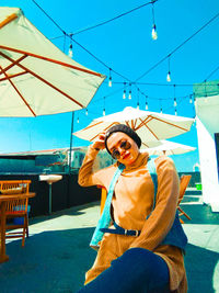 Portrait of woman with sunglasses against sky