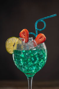 Close-up of wine glass against black background