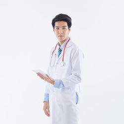 Young man standing against white background