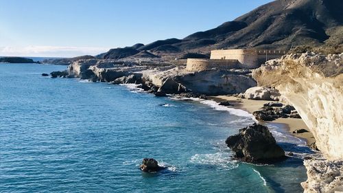 Scenic view of sea and rock formations against sky