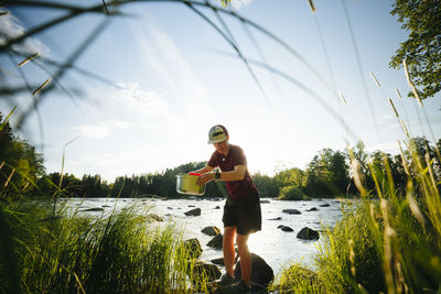 Young man at camping at lakeside