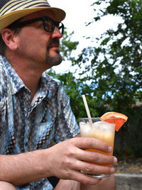 Midsection of man holding a drink