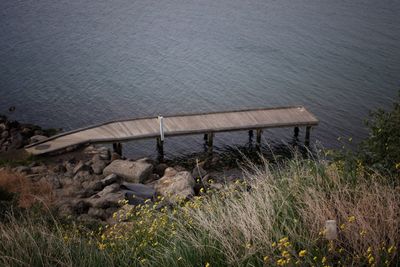 High angle view of grass by sea