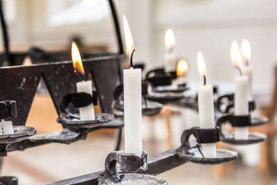 Close-up of burning candles in church