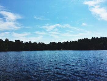 Scenic view of calm lake against cloudy sky