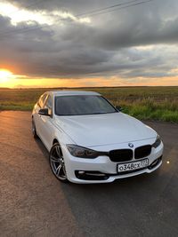 View of car on road during sunset