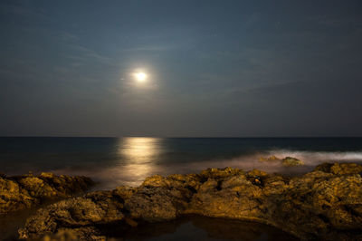 Scenic view of sea against sky at night