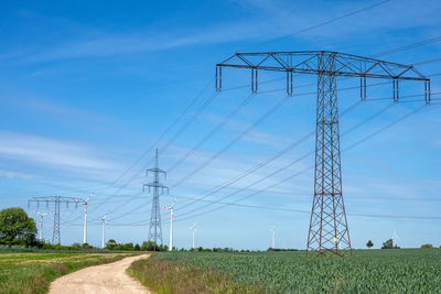 Overhead power lines and some modern wind turbines seen in germany