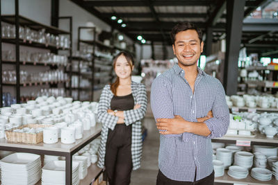 Portrait of young woman standing in store