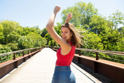 Teenage girl standing on footbridge