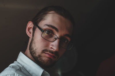 Portrait of man against black background