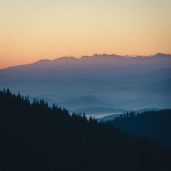 Scenic view of silhouette mountains against sky during sunset