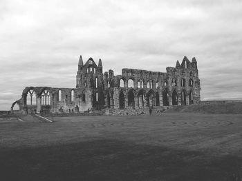 Old ruins of building against cloudy sky