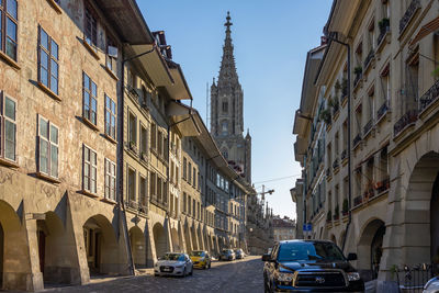Cars on street amidst buildings in city