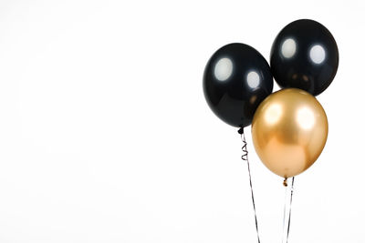 Low angle view of balloons against white background