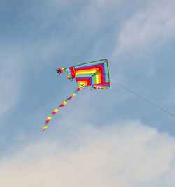 Colorful kite flies high in the blue sky symbol of freedom