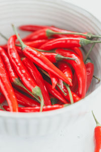 Close-up of red chili peppers in container