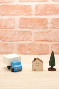 Close-up of toy car on table against wall