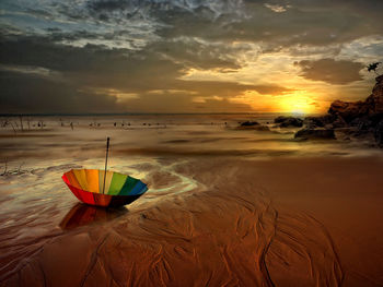 Scenic view of beach against sky during sunset