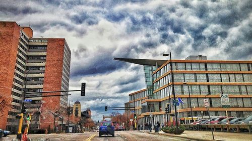 City buildings against cloudy sky