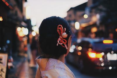 Woman standing on road at night