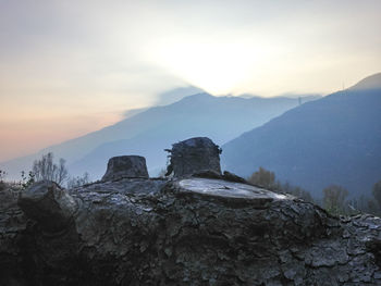 Scenic view of rocky mountains against sky during sunset