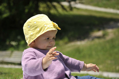 Cute girl sitting in park