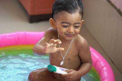 Portrait of a smiling girl holding water