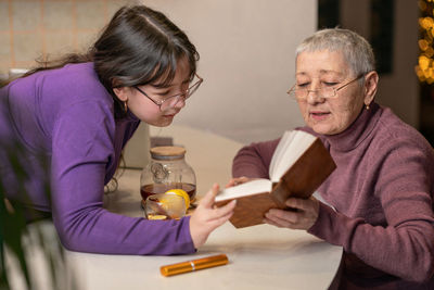 Side view of senior male friends working at home