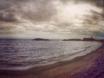 Scenic view of sea against cloudy sky