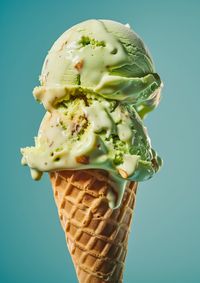 Close-up of ice cream cone against blue background