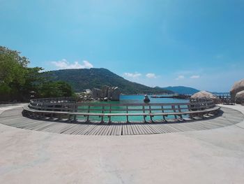 Scenic view of sea and mountains against sky