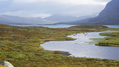 Scenic view of lake and mountains against sky